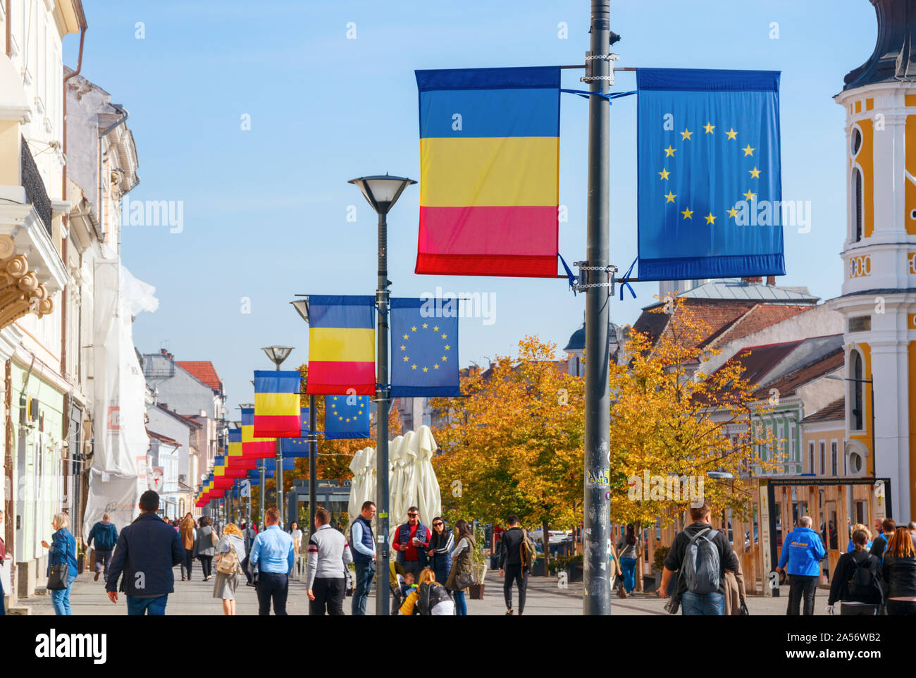 Line of street lanterns with flags of the European Union and Romania at the Avenue Eroilor. Cluj-Napoca, Romania Stock Photo