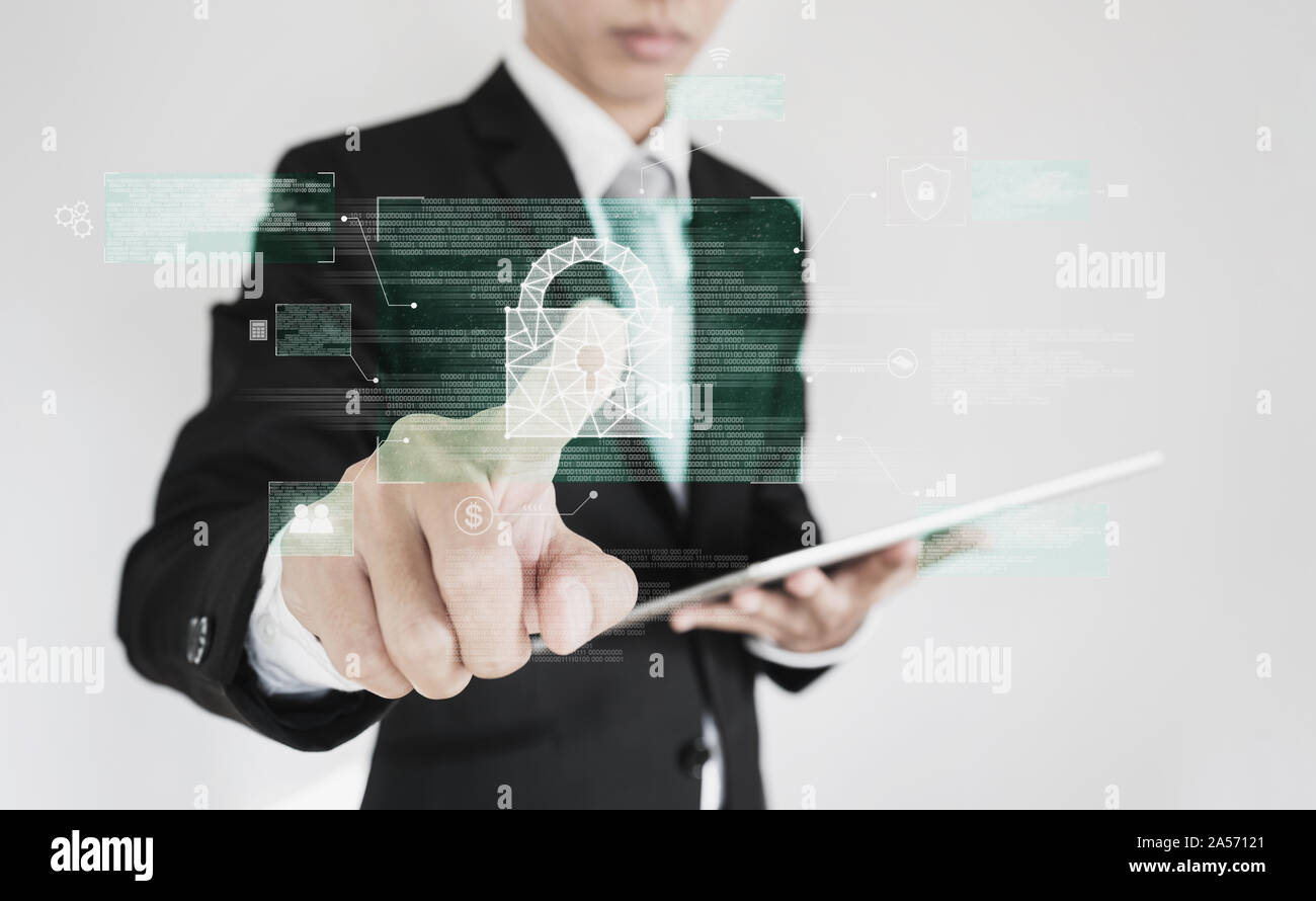 Businessman pressing on digital lock icon on screen. Business data security system technology Stock Photo