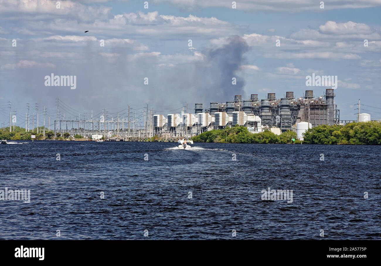 4 boats underway, powerboats, sailboat, motion, passing Florida Power & Light plant; electric