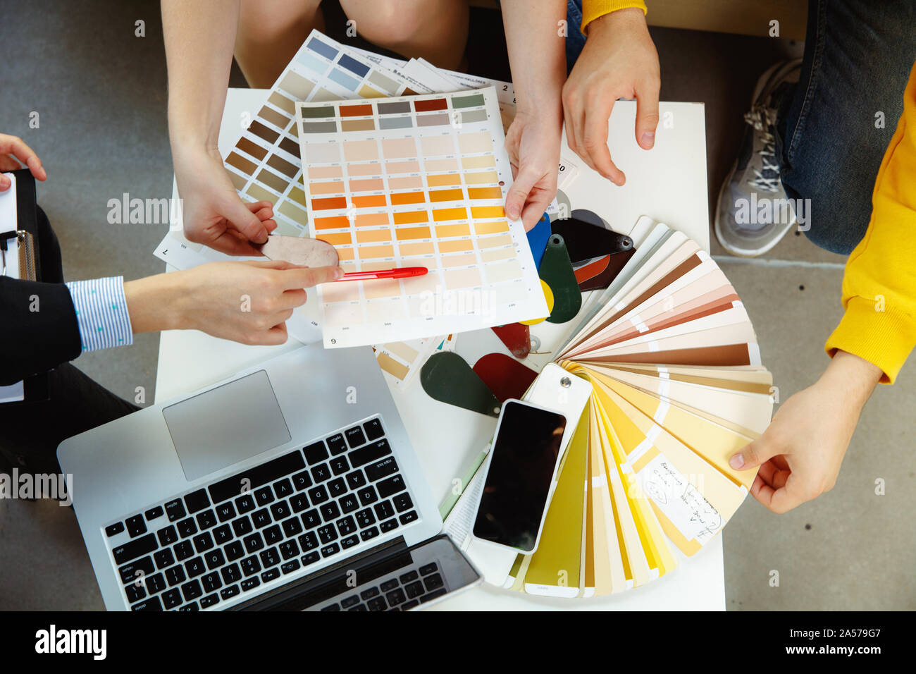 Interior designer working with young couple. Lovely family and ...