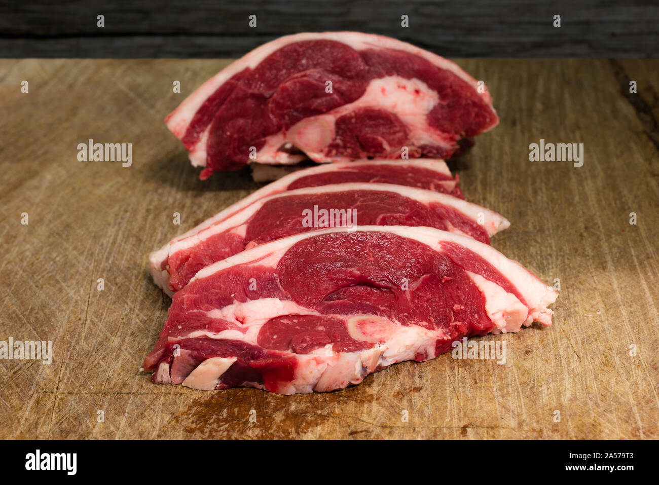 Fresh English Lamb Chump Chops, cut on a wooden butchers block Stock Photo