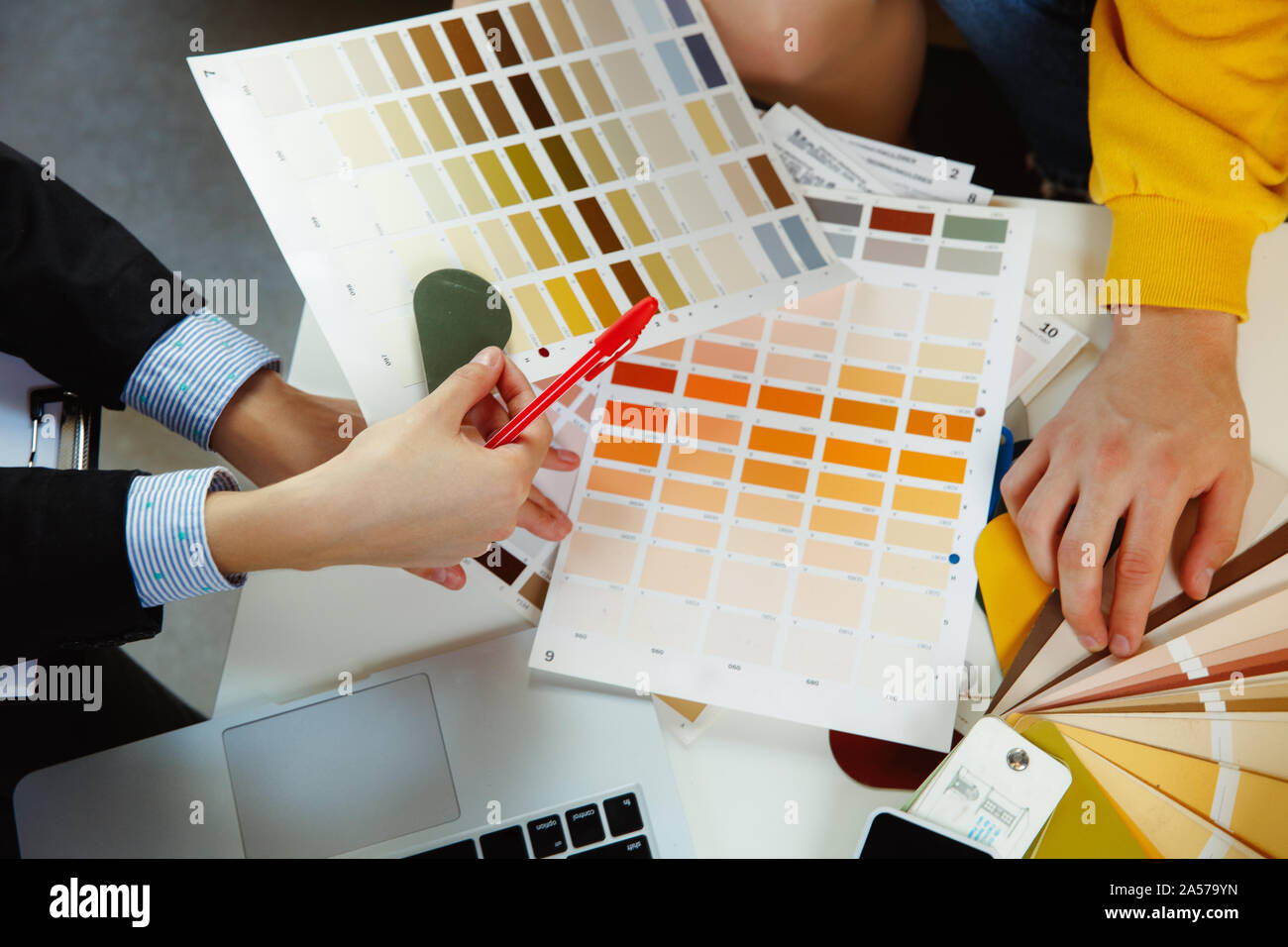 Interior designer working with young couple. Lovely family and ...