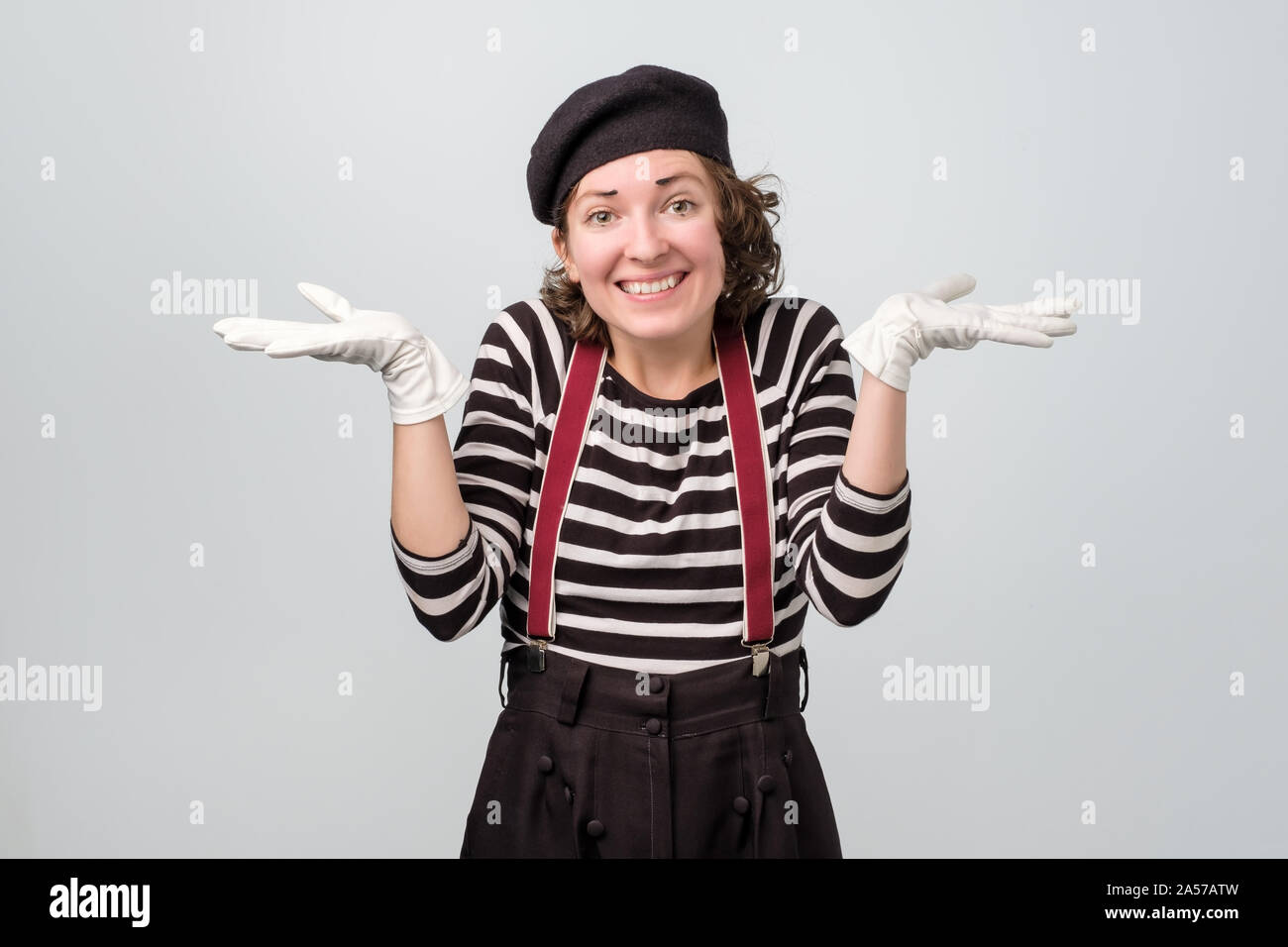 Shrugging caucasian mime woman in doubt doing shrug. Do not know sign Stock Photo