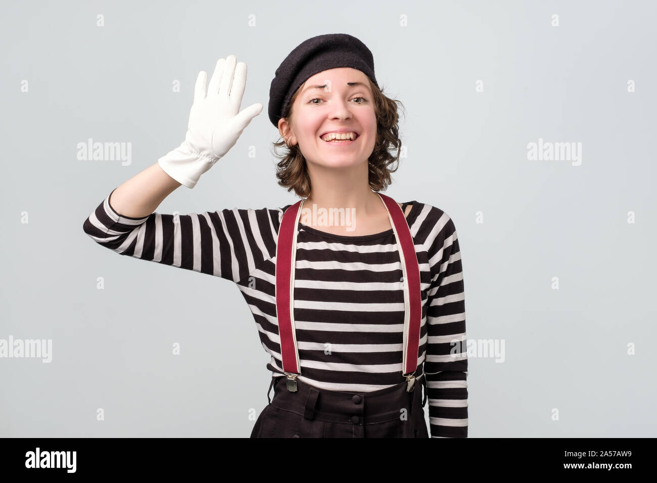 Pretty caucasian mime girl waving hands saying hello Stock Photo