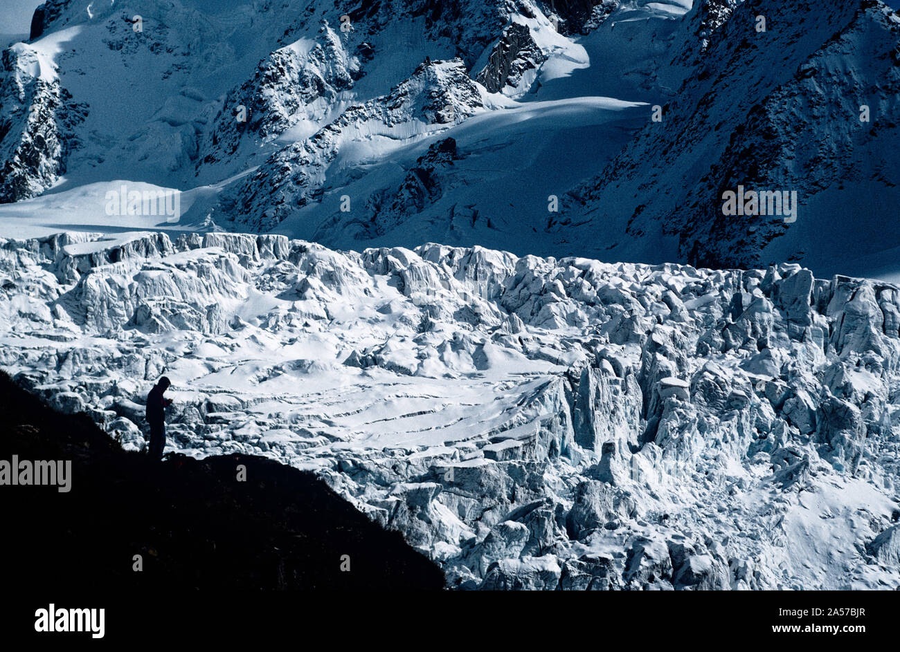 A trekker silhouetted against the icefall of the Le Tour glacier near Chamonix in the French Alps Stock Photo