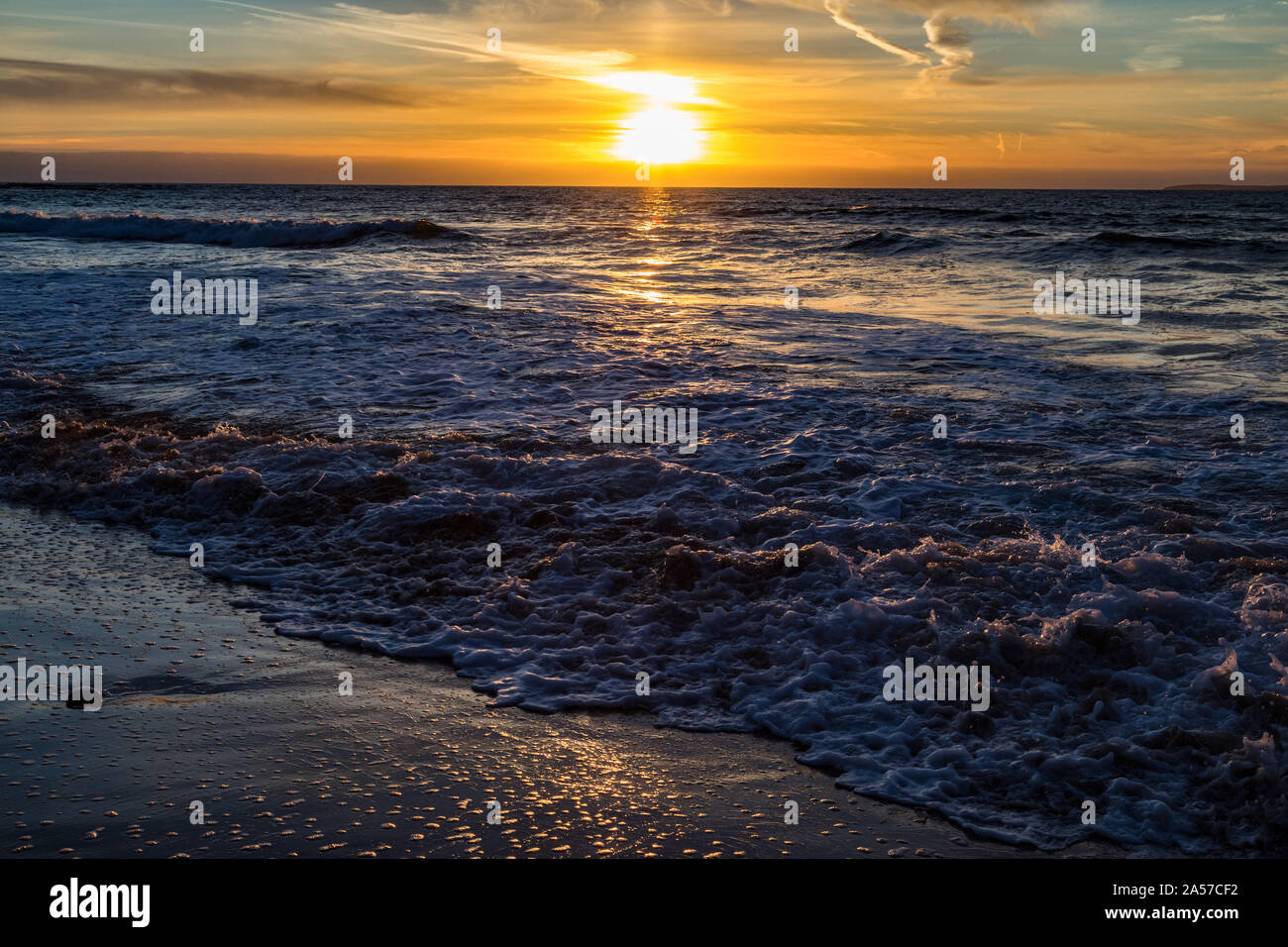 Surf foam beach sunset Stock Photo