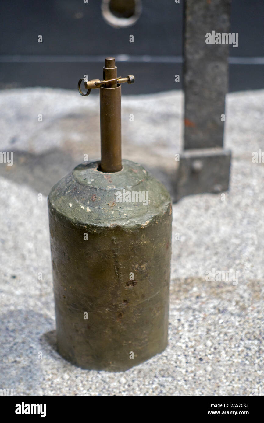 WW2 / World War Two German concrete stock mine / anti-personnel mine with brass trip wire mine fuze / igniter Stock Photo