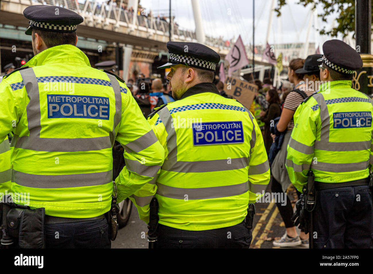 London, UK. 18th Oct 2019. Extinction Rebellion demonstrators watched by Metropolitan police officers during Central London climate change protest Credit: Ricci Fothergill/Alamy Live News Stock Photo
