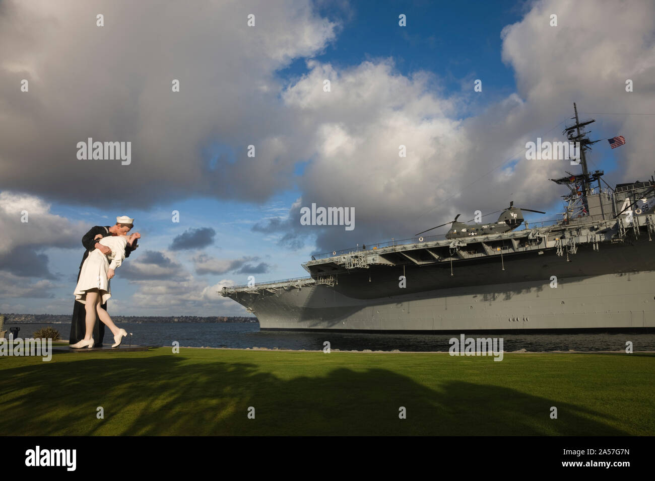 Sculpture Unconditional Surrender with USS Midway aircraft carrier, San Diego, California, USA Stock Photo