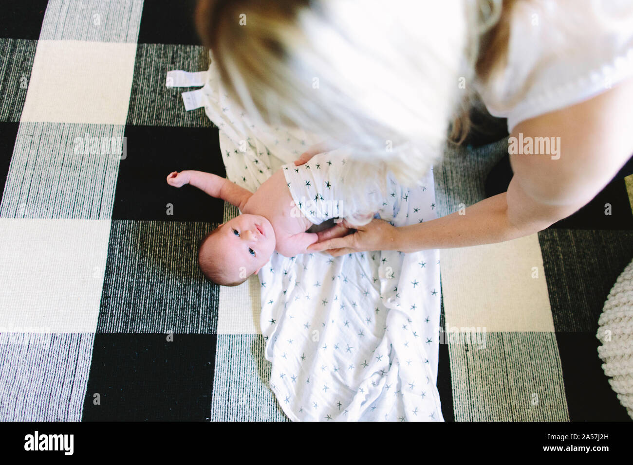 Mom swaddling baby hires stock photography and images Alamy