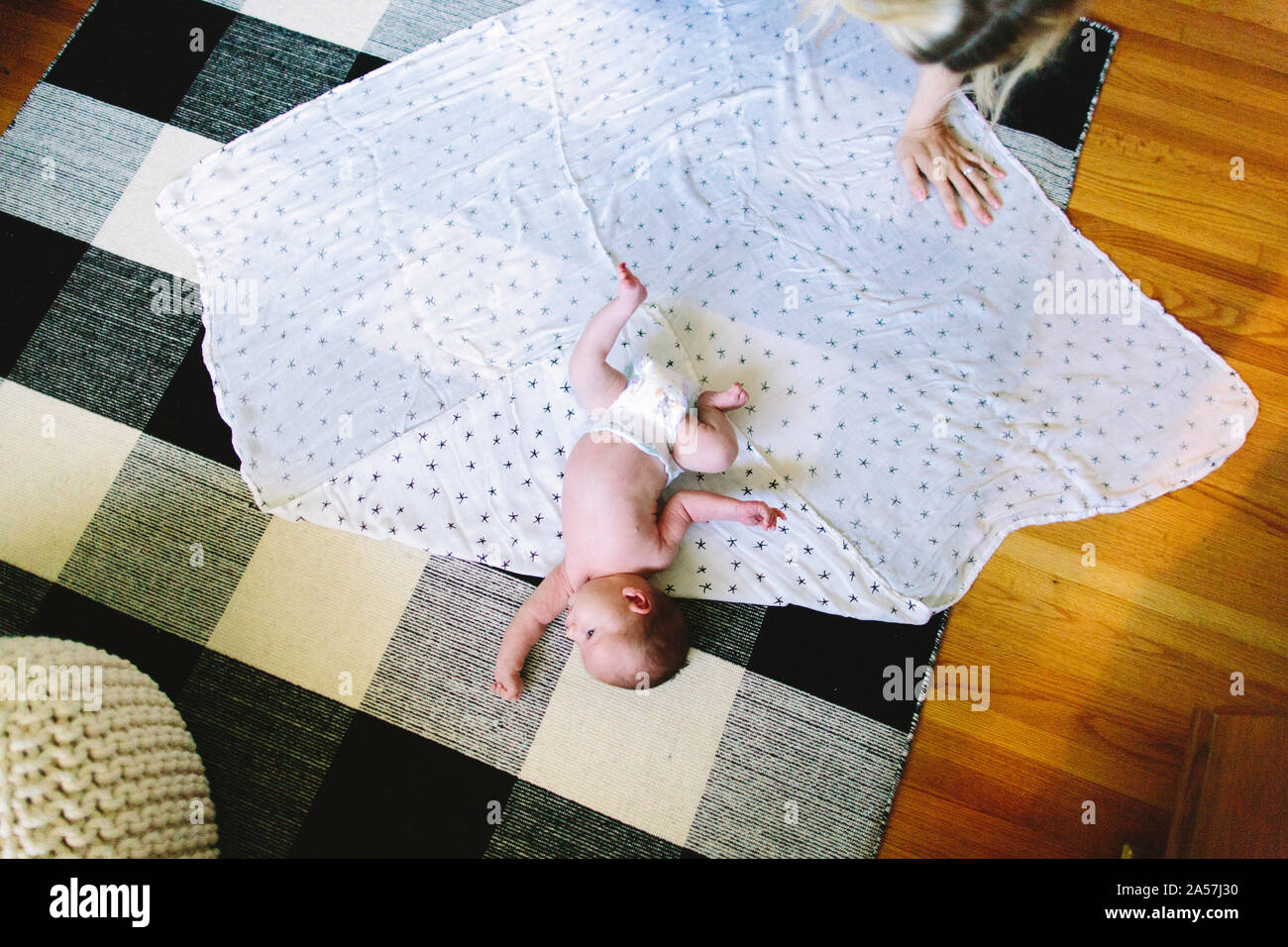 An overhead view of a newborn baby boy laying on a blanket Stock Photo