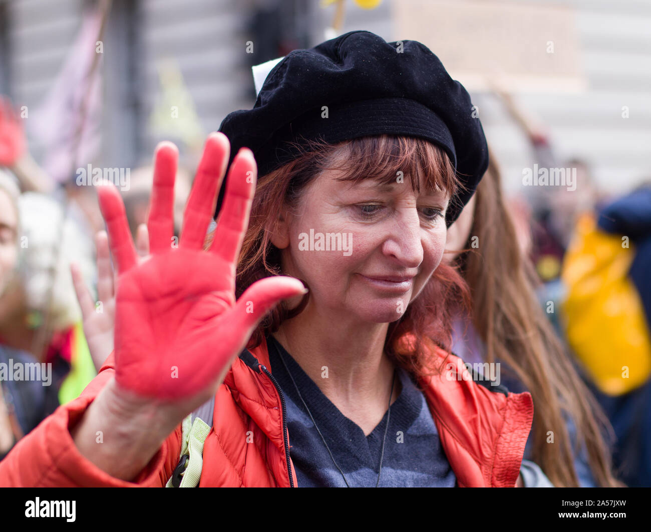 Whitehall, London, UK. 18 October 2019. Environmental campaigners Extinction Rebellion, including Red Rebellion, families and young children protest along Whitehall to reach outside the gates of Downing Street. Activists sing and hold their hands which are painted red to symbolise blood. Protesters demand decisive action from the UK Government on the global environmental crisis. Stock Photo
