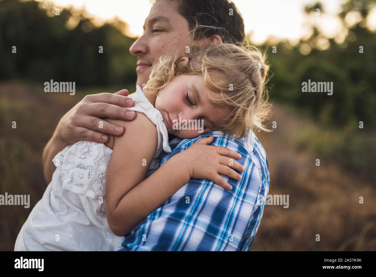 4 yr old girl asleep on her dad' shoulder - B/W photo Stock Photo