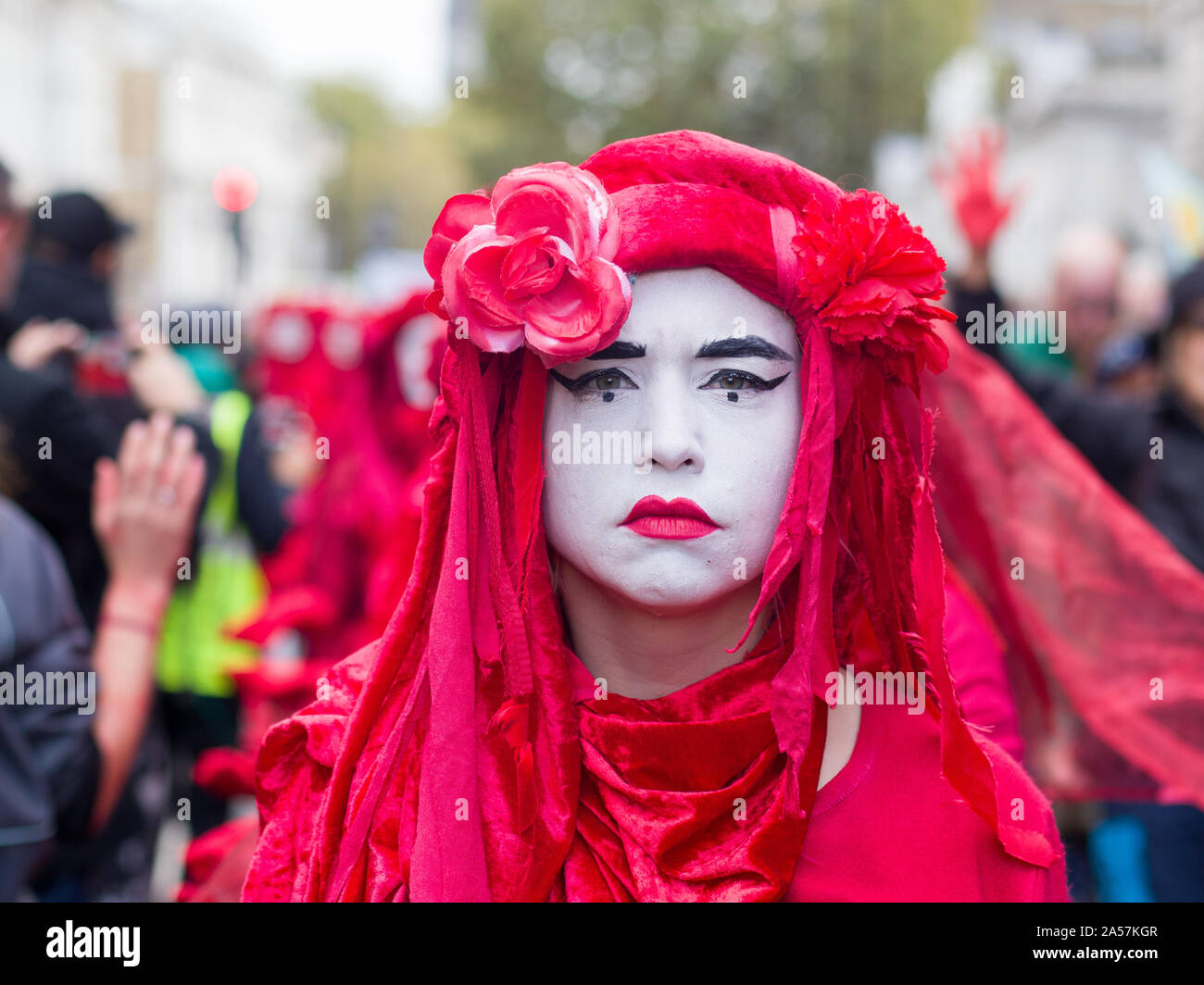 Whitehall, London, UK. 18 October 2019. Environmental campaigners Extinction Rebellion, including Red Rebellion, families and young children protest along Whitehall to reach outside the gates of Downing Street. Activists sing and hold their hands which are painted red to symbolise blood. Protesters demand decisive action from the UK Government on the global environmental crisis. Stock Photo