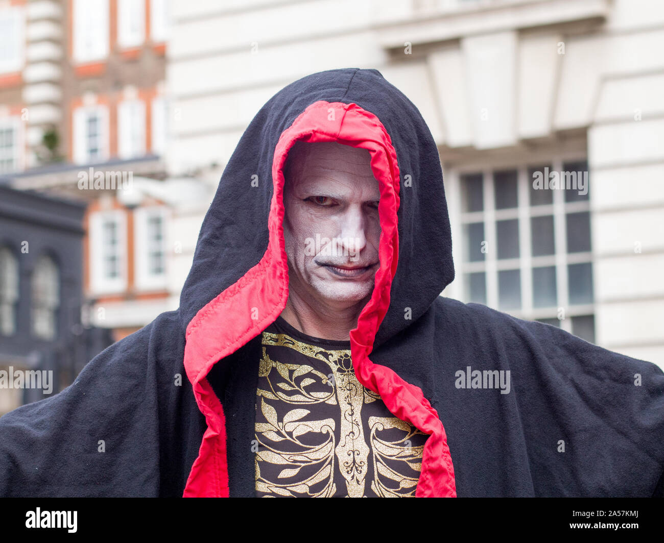 Whitehall, London, UK. 18 October 2019. Environmental campaigners Extinction Rebellion, including Red Rebellion, families and young children protest along Whitehall to reach outside the gates of Downing Street. Activists sing and hold their hands which are painted red to symbolise blood. Protesters demand decisive action from the UK Government on the global environmental crisis. Stock Photo