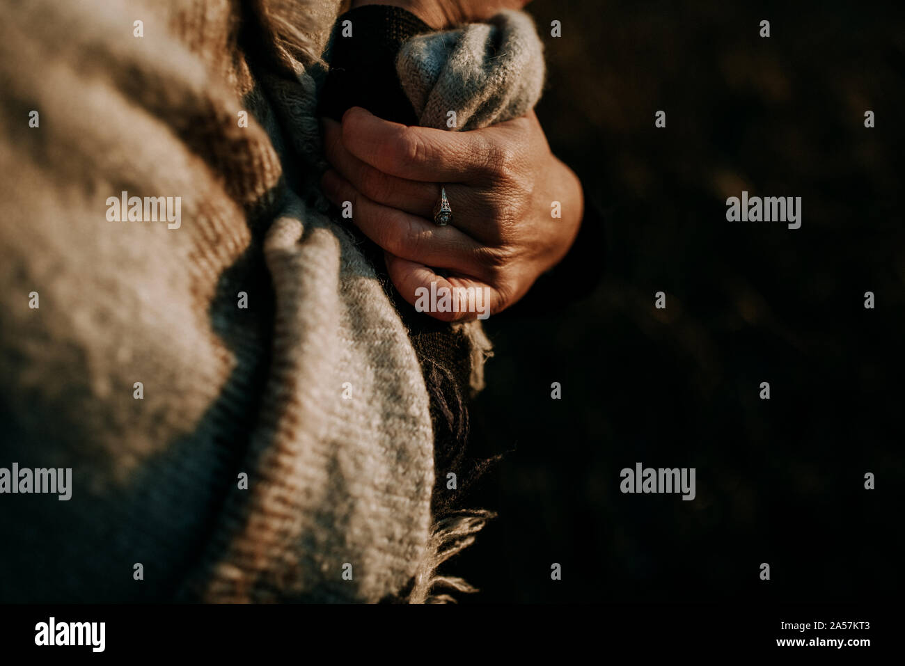 closeup of ring on woman's hand at sunset Stock Photo