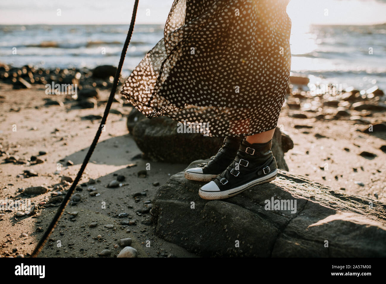 woman standing in dress on beach Stock Photo - Alamy