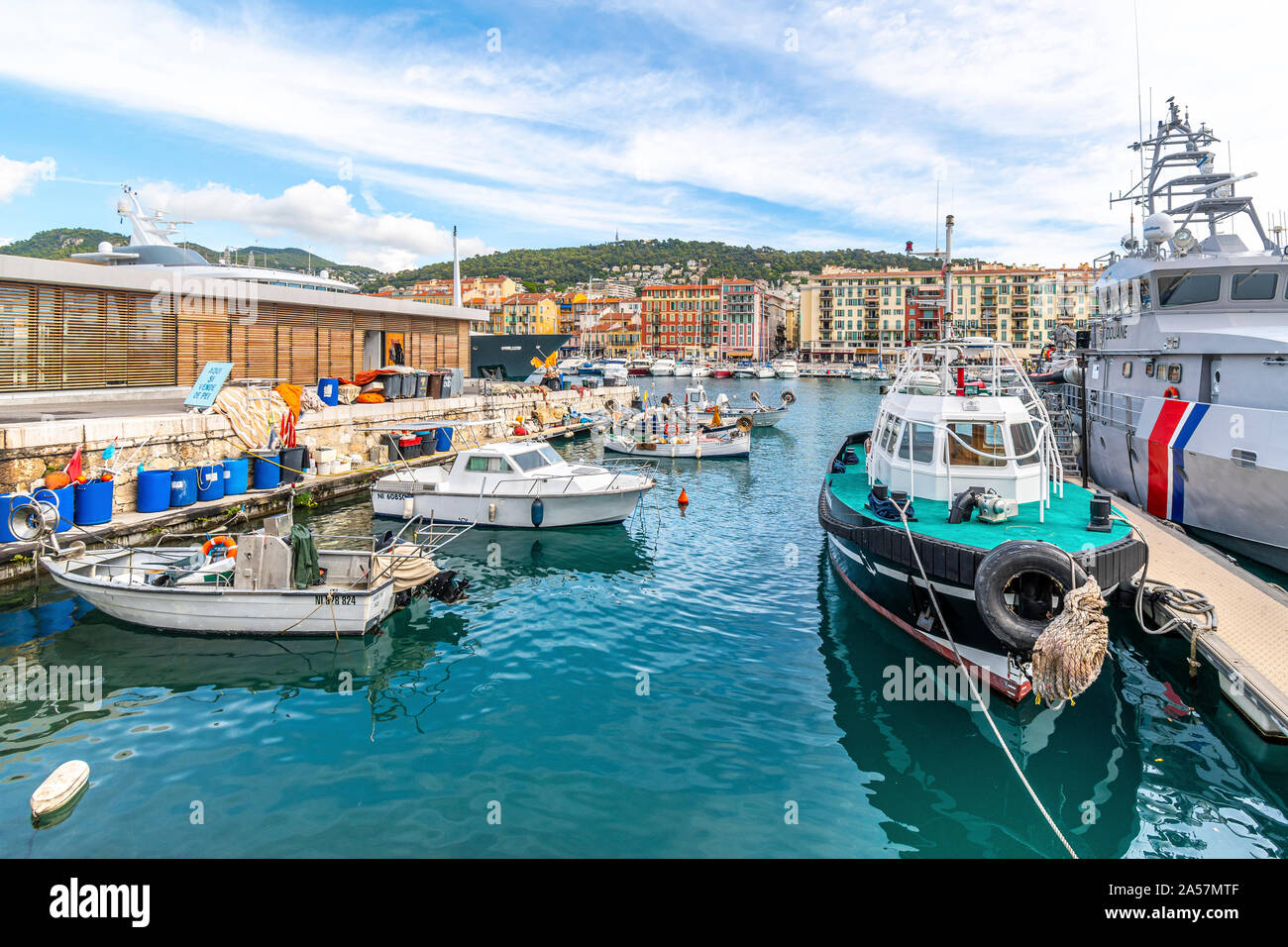 An assortment of boats and watercraft in the old harbor of Port Lympia in the city of Nice France, on the Mediterranean Sea at the French Riviera. Stock Photo