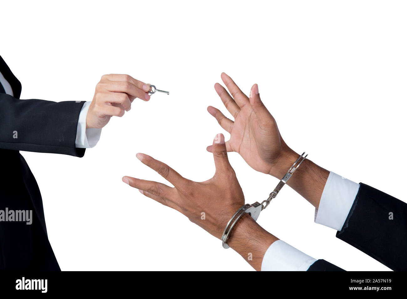 businessman in handcuffs and woman hand offering key solving business ideas concept isolated on white background Stock Photo