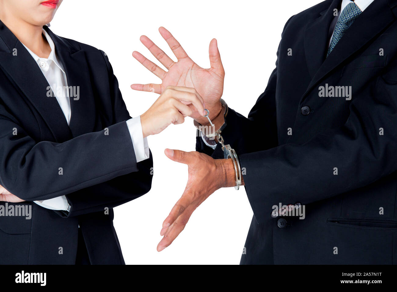 businessman in handcuffs and woman hand offering key solving business ideas concept isolated on white background Stock Photo