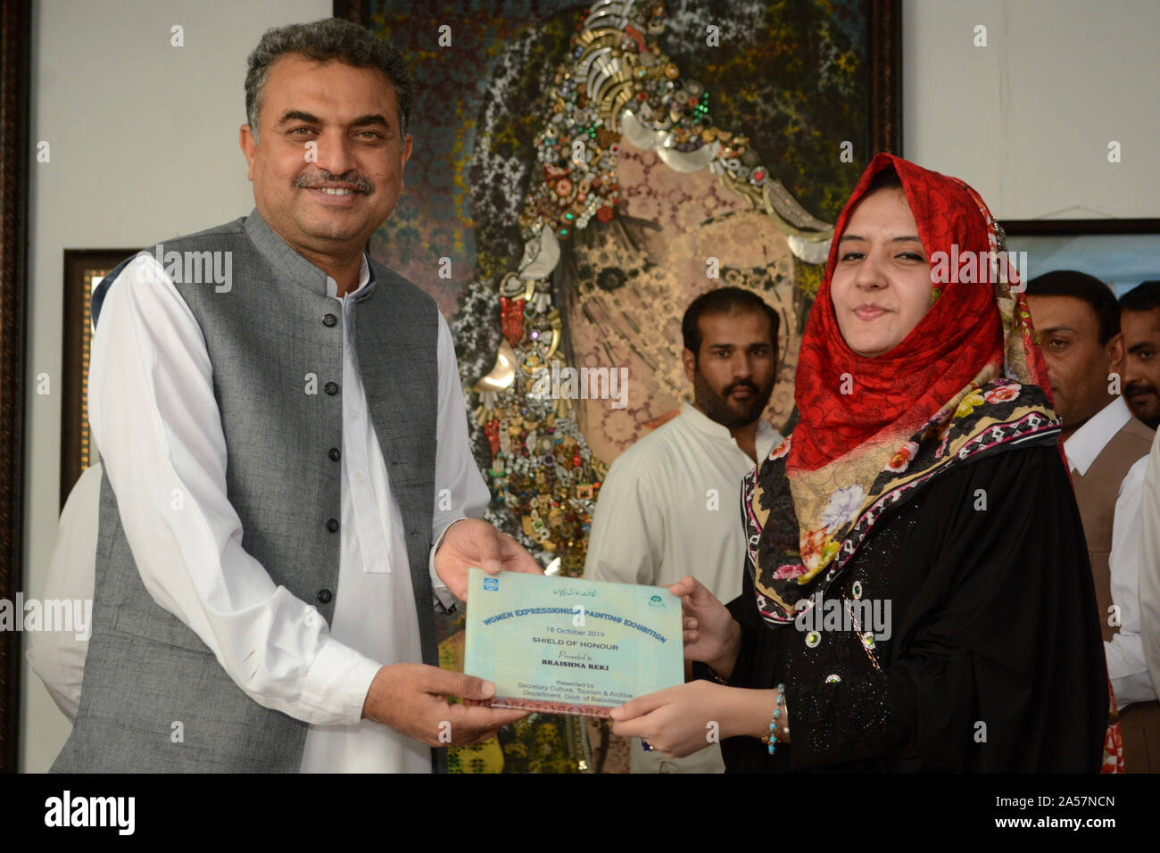 Quetta, Pakistan. 18th Oct, 2019. Secretary for Culture, Tourism and Archive department Mr. Zafar Ali Buledi giving award to fine art student during women expressionism painting exhibition at Art Council Balochistan organized by culture, tourism and archive department government of Balochistan. (Photo by Din Muhammad Watanpaal/Pacific Press) Credit: Pacific Press Agency/Alamy Live News Stock Photo