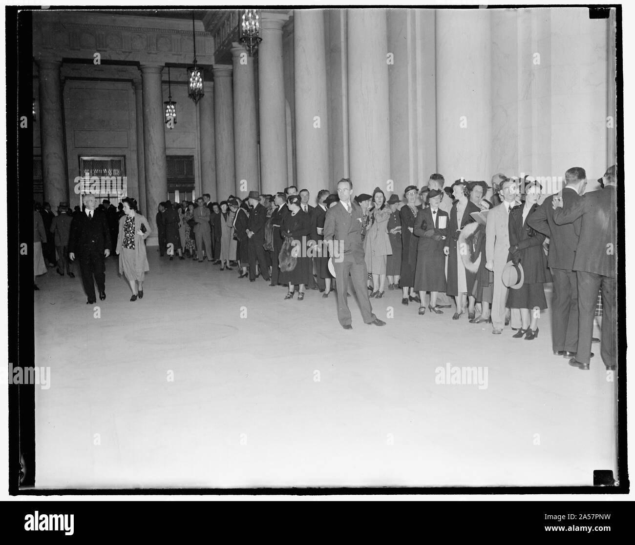 Waiting to enter Supreme Court chamber. Washington, D.C., Oct. 4. A crowd gathered in the Supreme Court Building as early as 8 A.M. today waiting for a chance to enter the court chamber and witness the swearing in of Justice Hugo L. Black. 10/4/37 Stock Photo