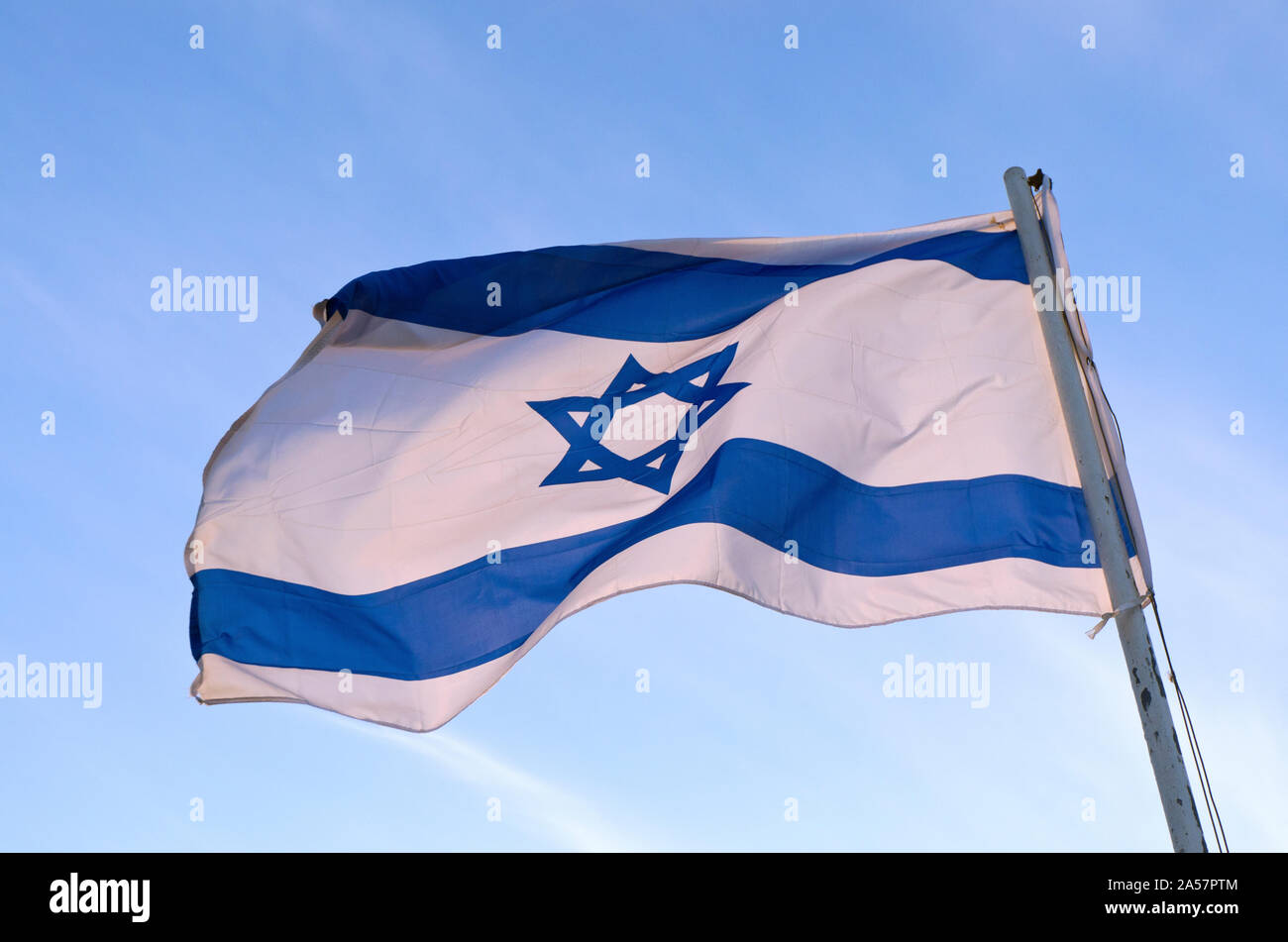 Low angle view of an Israeli Flag fluttering, Israel Stock Photo
