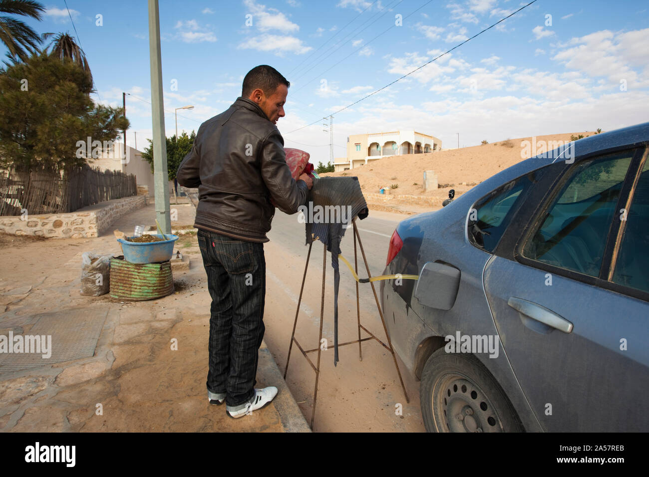 Man refueling car with petrol, Matmata, El Ksour, Kef Governorate, Tunisia Stock Photo