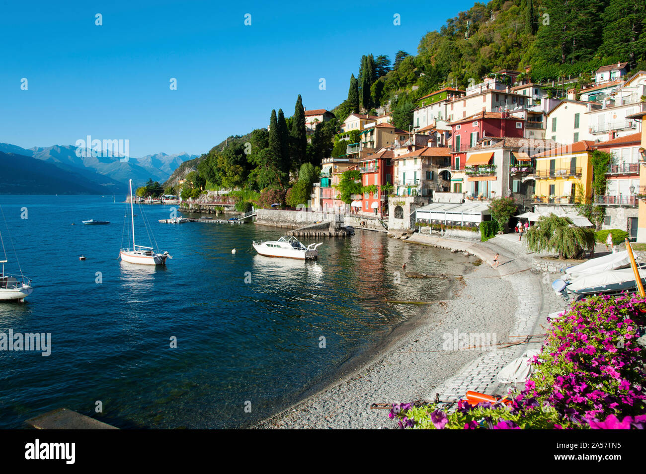 Houses at waterfront with boats on Lake Como, Varenna, Lombardy, Italy Stock Photo