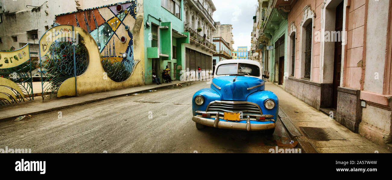Old car and a mural on a street, Havana, Cuba Stock Photo