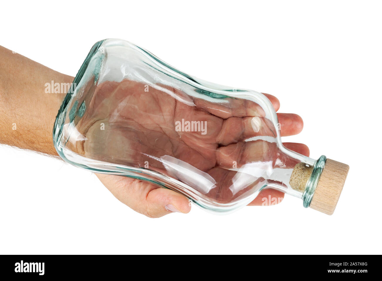 Hand holds an empty bottle with a cork. Stock Photo