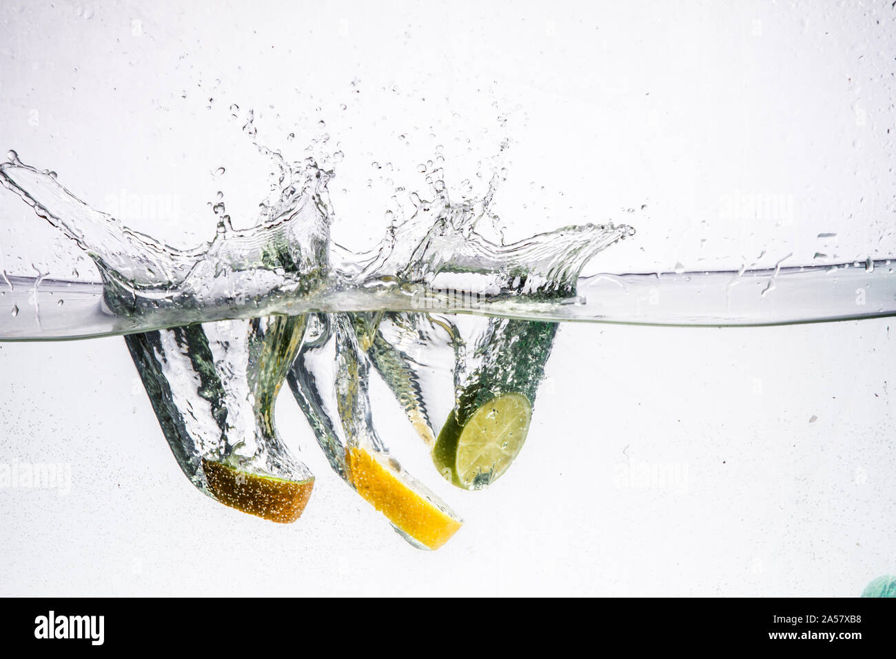 A background of bubbles forming in blue water after fruits is dropped ...