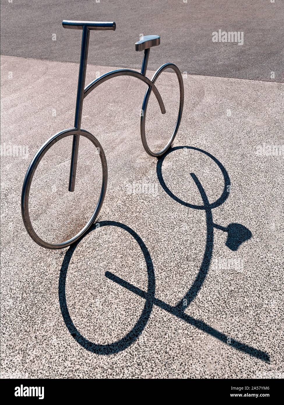 Bicycle, bicycle stand, stainless steel bicycle park, casts shadow, Aalborg, Jutland, Denmark Stock Photo