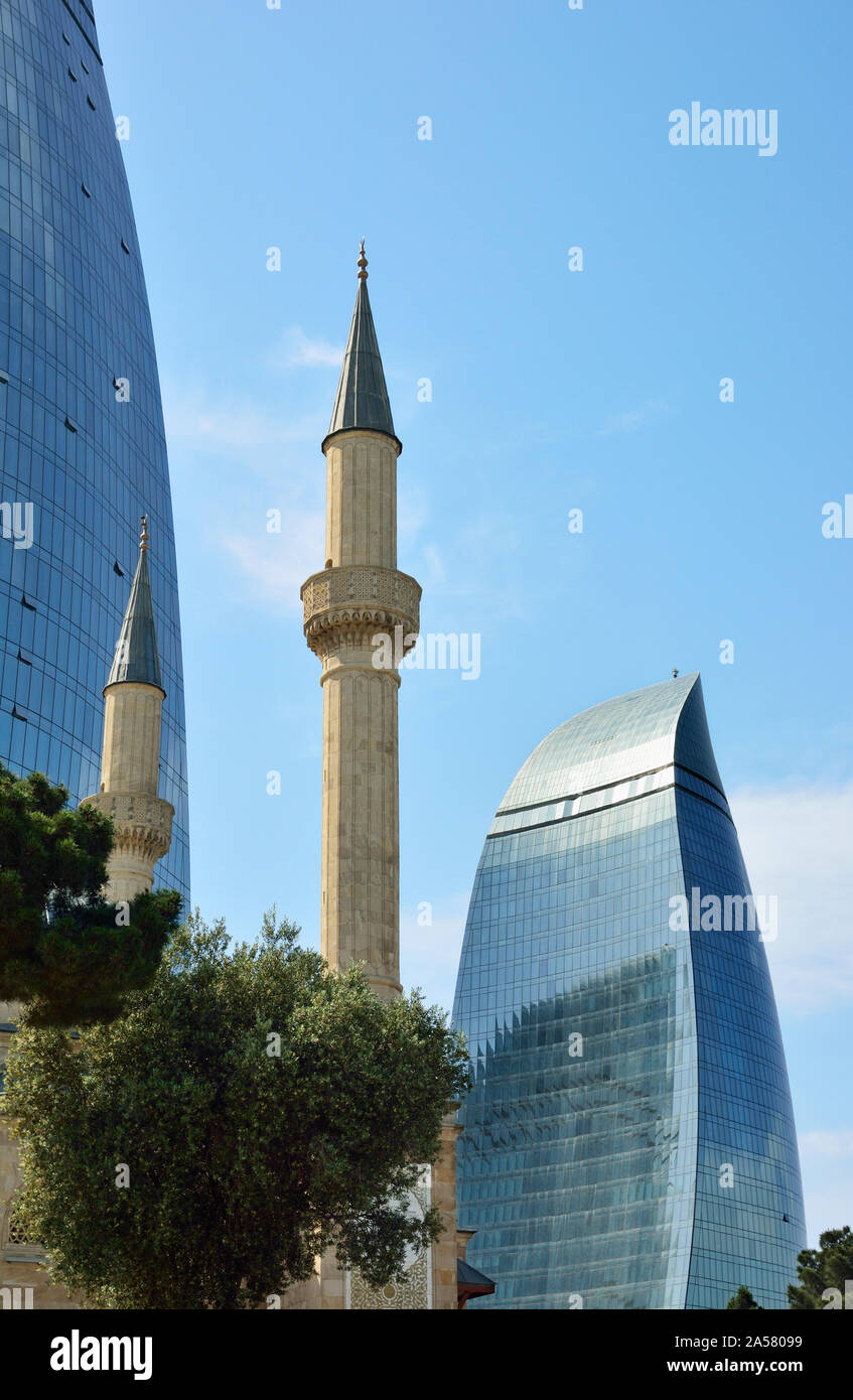 The minarets of Sahidlar Xiyabani Mosque and the Flame Towers. Baku, Azerbaijan Stock Photo