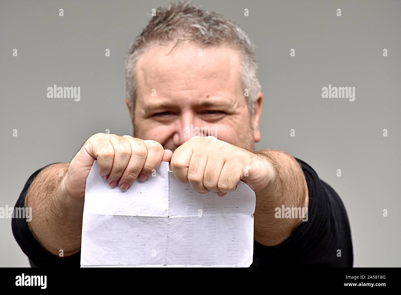 An Angry Overweight Man Reading Documents Stock Photo