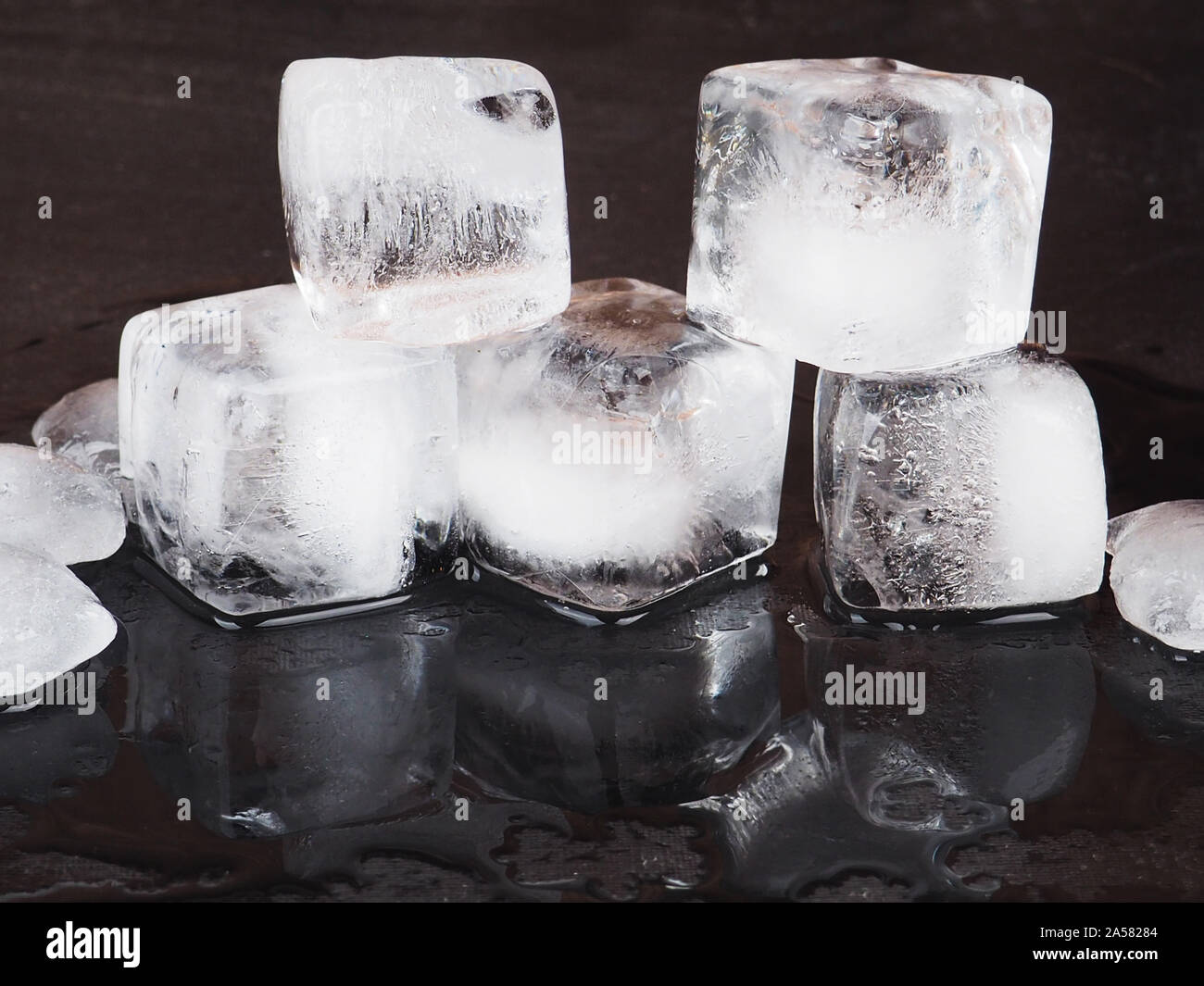 ice cubes on black table background with water drops Stock Photo - Alamy