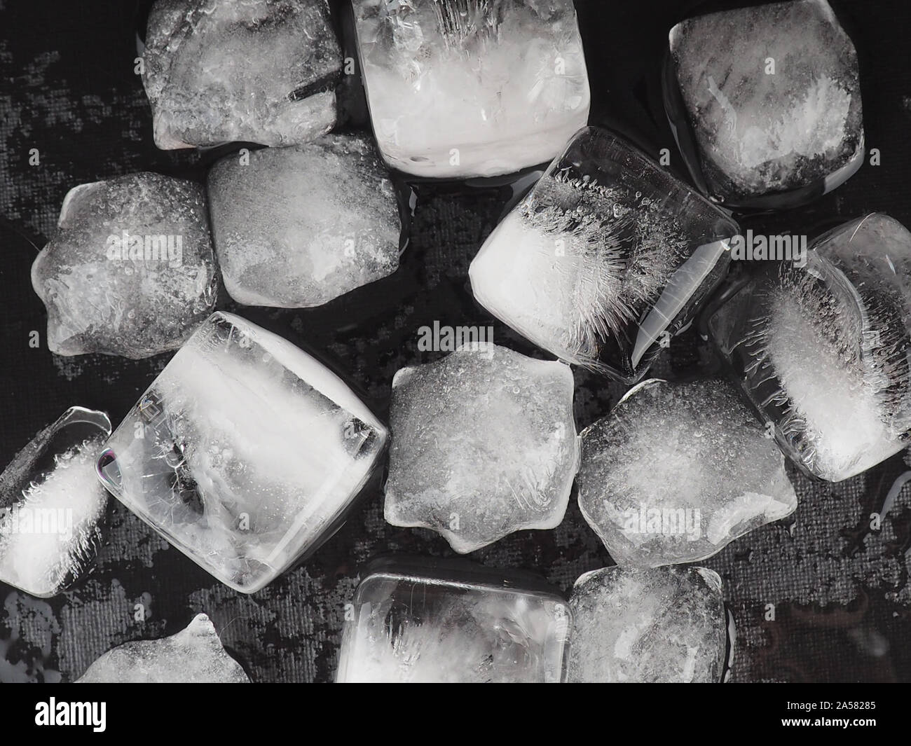 ice cubes on black table background with water drops Stock Photo - Alamy