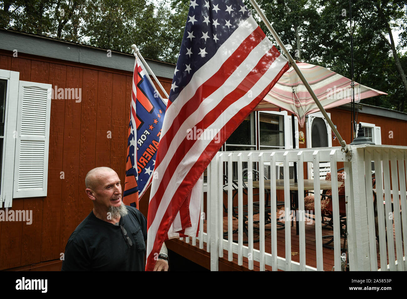 Dahlonega, Georgia, USA. 18th Sep, 2019. Outside his house, Doles flies the American flag and a Trump flag. Doles said that to him, America means 'the continuation of Western civilization, a way of life, to be patriotic, to hang on to our institutions as they had been''¦ and since we were from old Europe, to hang on to marriage between a man and a woman, to the idea that life starts in conception. These are the things that are the very fabric of western civilization, and the world as we know it, and in the horizon is a growing trend of liberalism, socialism, that will''¦destroy our very w Stock Photo