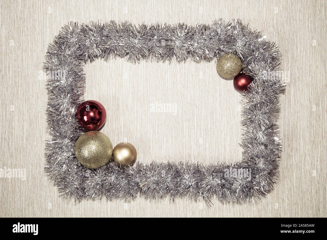 Frame made from silver tinsel decorations for christmas. Christmas tinsel garland, forming a rectangular frame with center copy space. tinsel frame background Stock Photo