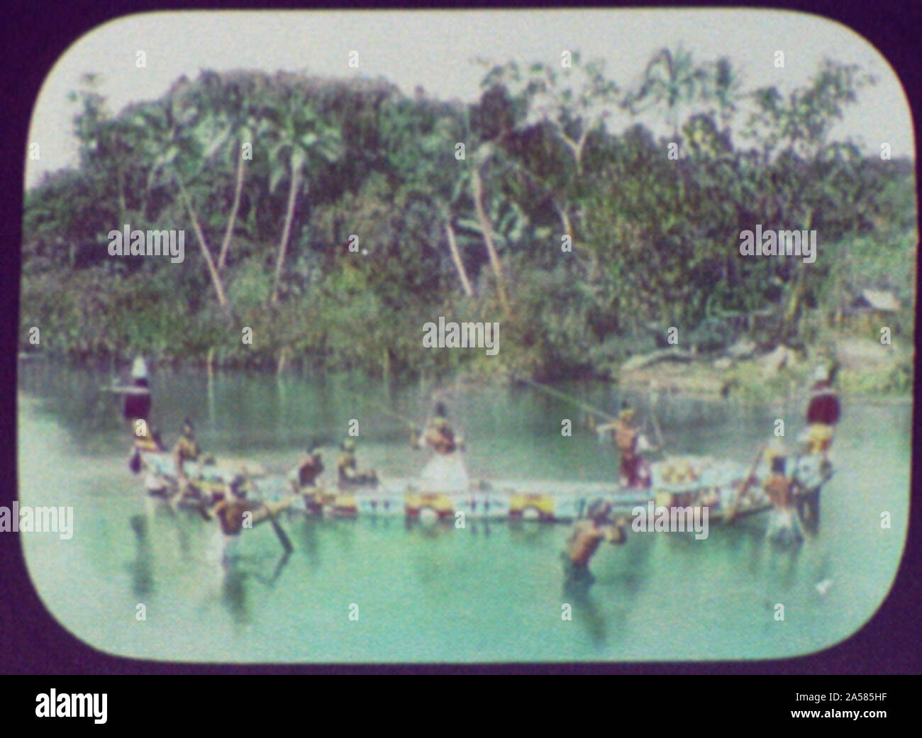 Warriors with spears in ornamented war canoe Stock Photo