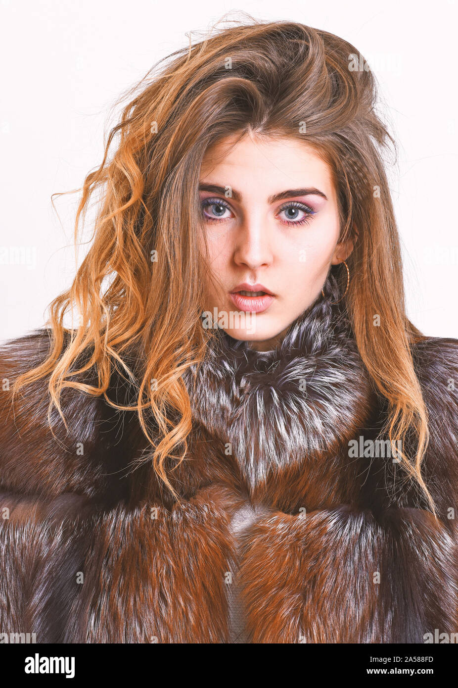 Winter hair care tips you should follow. Hair care concept. Girl fur coat  posing with hairstyle on white background close up. Prevent winter hair  damage. Woman makeup calm face hair volume hairstyle