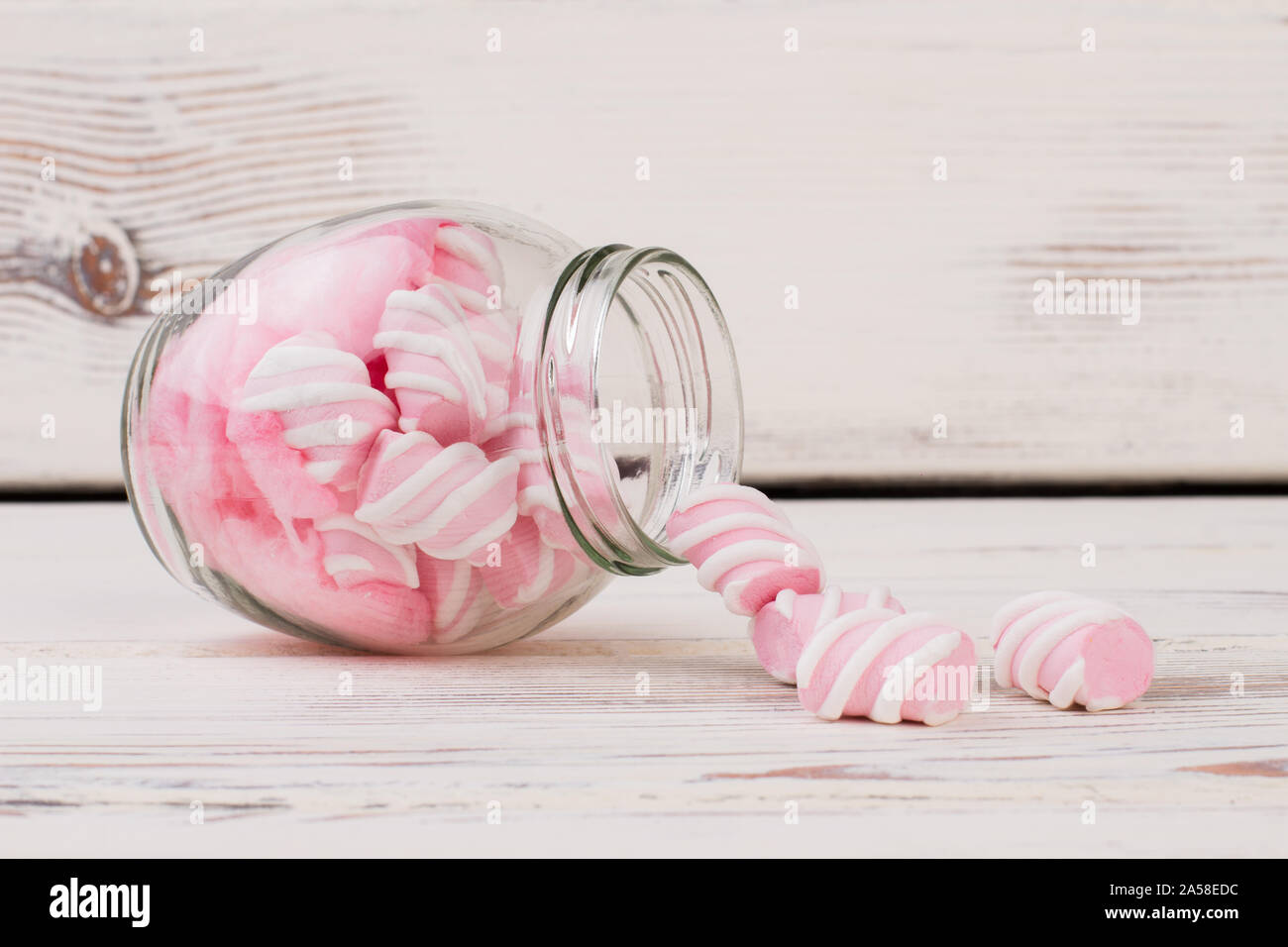 Pink marshmallows on white wooden background. Stock Photo