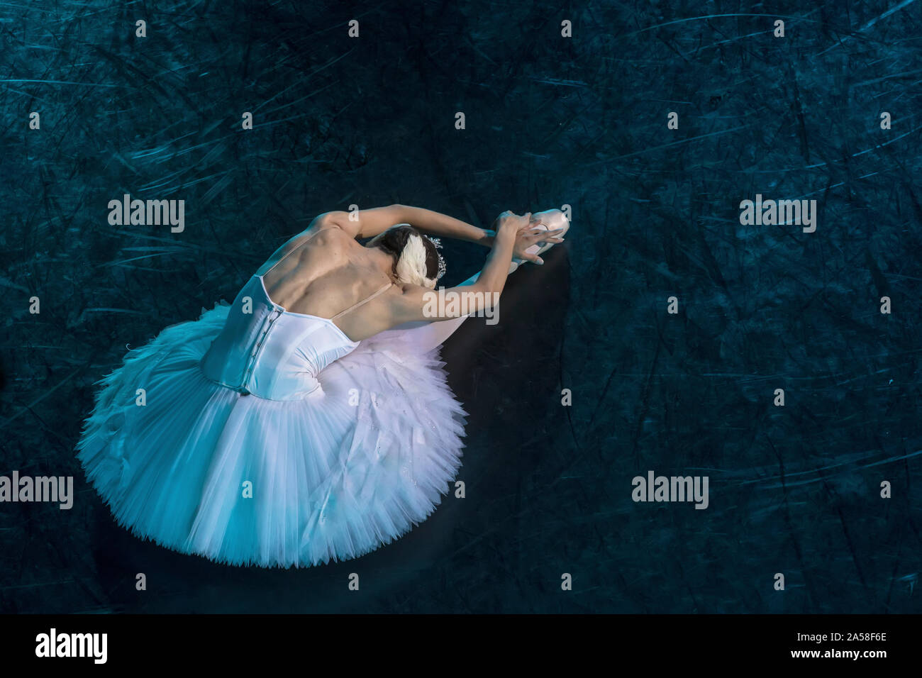 A prima ballerina in the role of 'Odette' in the scene of the ballet 'Swan Lake' performs at the theater stage in Moscow, Russia Stock Photo