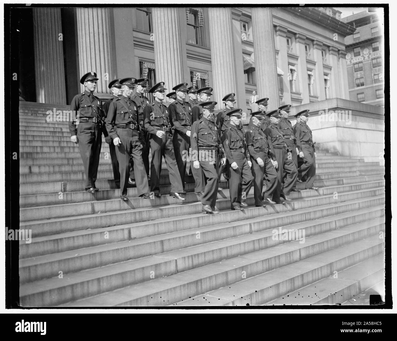 U.S. Treasury guards blossom out in new uniforms. Washington, D.C. Aug. 26. The first act of the U.S. Secret Service when they were g even supervision of the Treasury Guards was to outfit the men with new uniforms. A neat summer uniform of blue shirt with blue trousers and Sam Browne belt was taken the place of the blue, green, white, pink and other conflicting colors in shirts formerly worn by the guards. This picture was made as the guards paraded for officials of the Treasury today. 8/26/37 Stock Photo