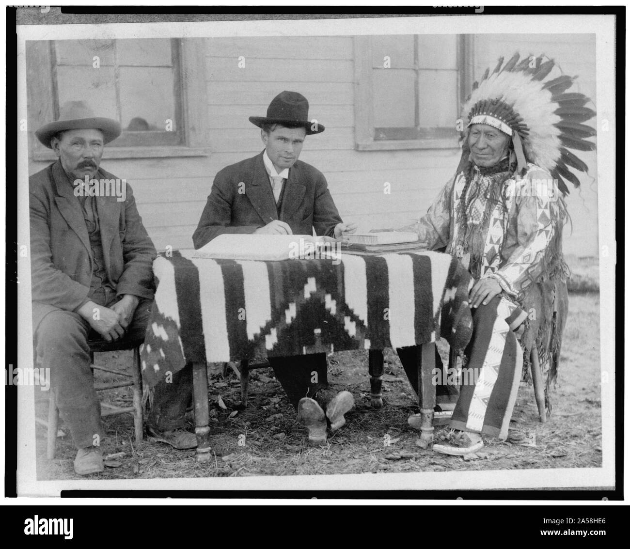 U.S. allotting surveyor and his interpreter making an American citizen of Chief American Horse, Oglala Sioux Stock Photo