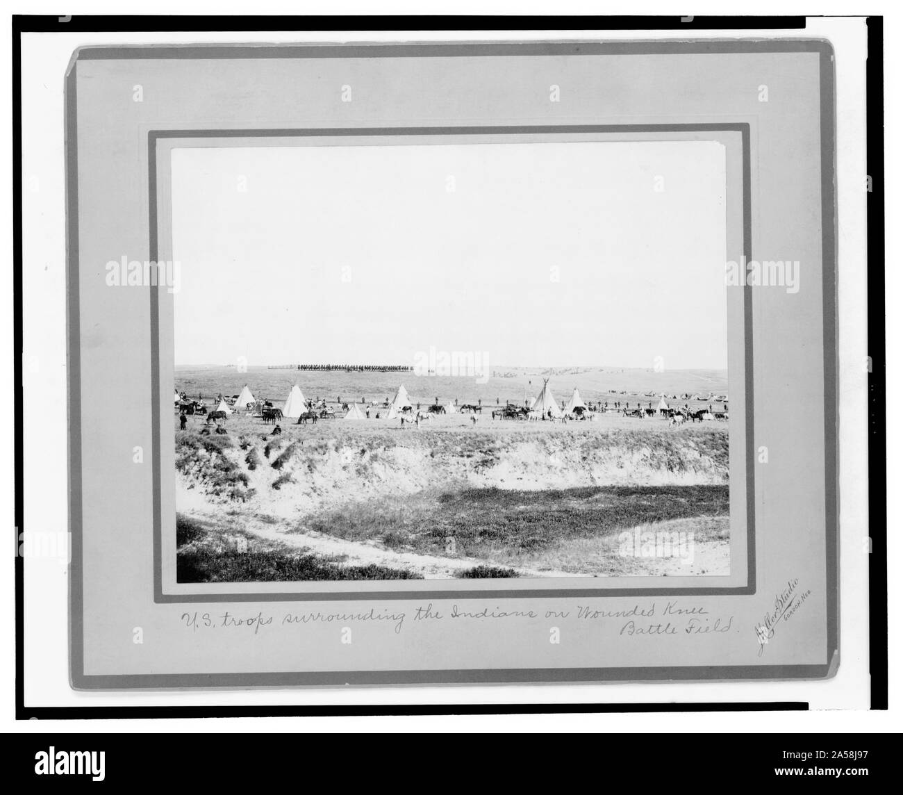 U.S. troops surrounding the Indians on Wounded Knee battle field / Miller Studio, Gordon, Neb. Stock Photo
