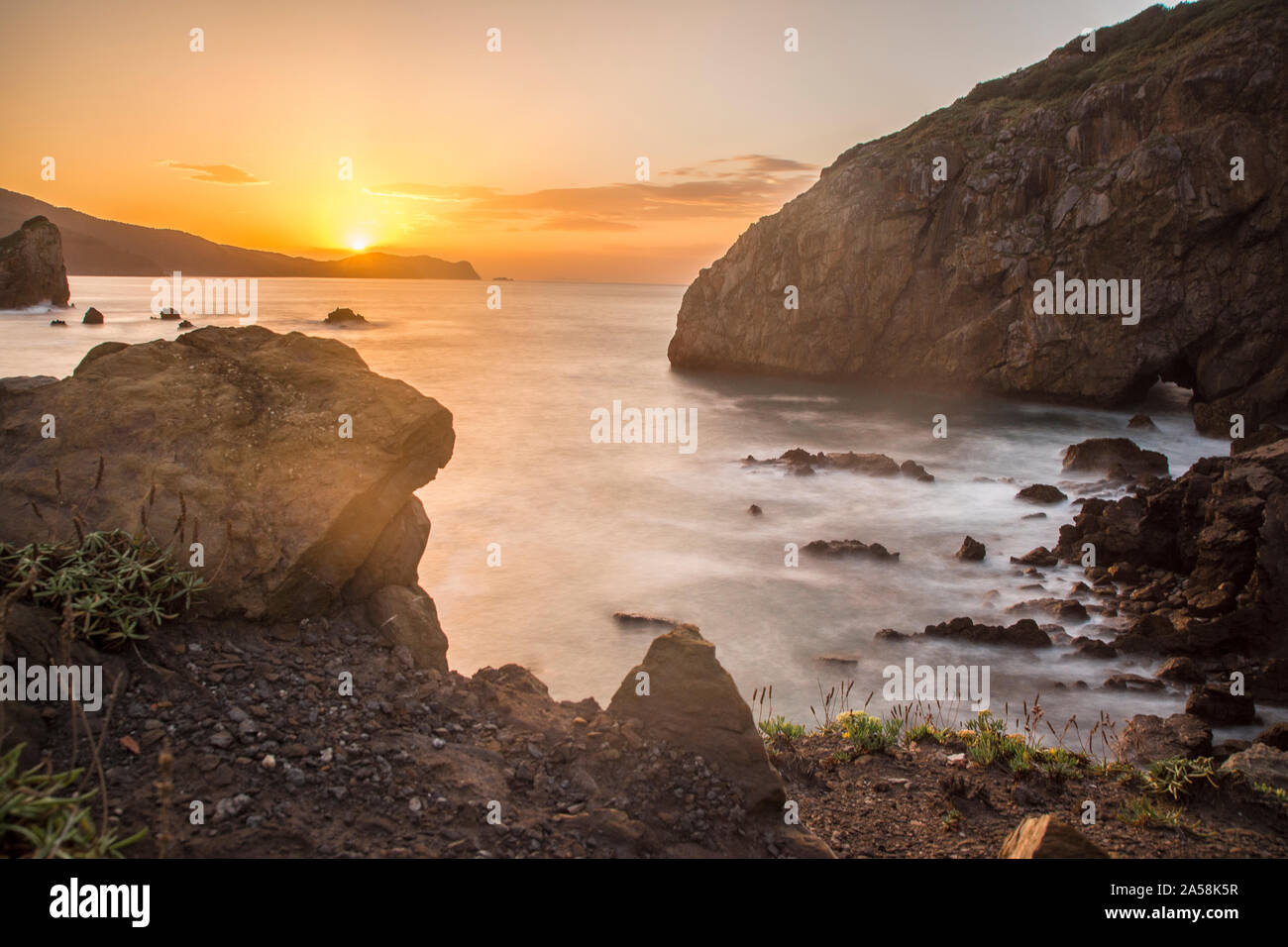 sunset at the basque coast in gaztelugatxe, northern spain Stock Photo