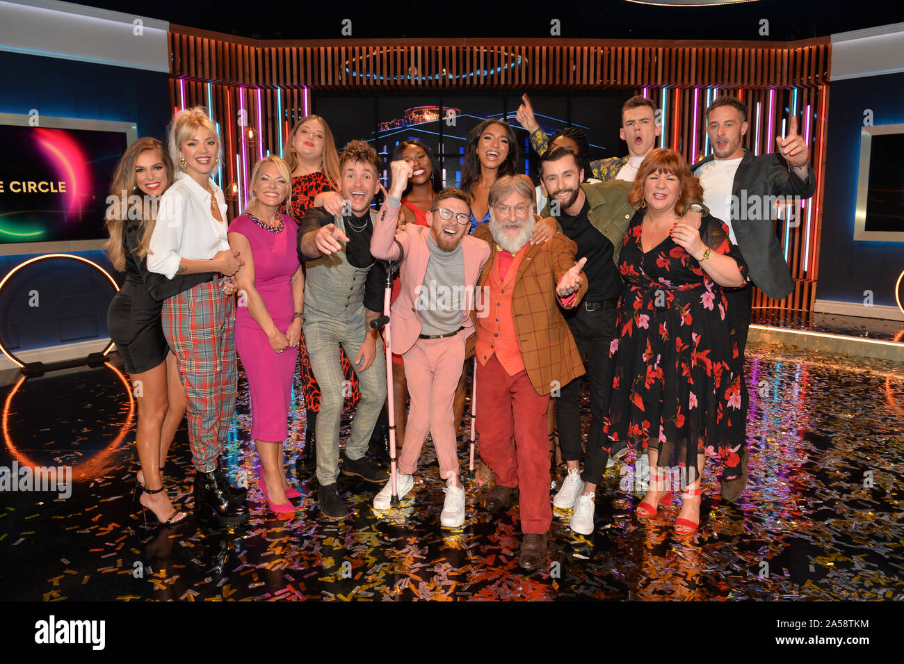 (left to right) Beth Dunlavey, Emelle Smith, Katie Roe Carr, Jack Quirk, Ella May, winner Paddy Smyth, Brooke Odunbaku, Georgina Elliott, Viewer's Champion Tim Wilson, Busayo Twins (hidden), James Doran, Woody Cook, Jan Jones and Sy Jennings celebrating after the final of the second series of Channel 4's The Circle in Salford, Manchester. PA Photo. Picture date: Friday October 18, 2019. See PA story SHOWBIZ Circle. Photo credit should read: Peter Powell/PA Wire Stock Photo