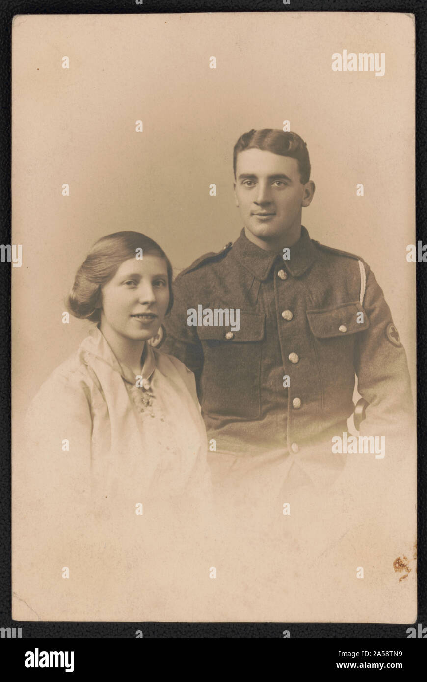 Unidentified soldier in American Expeditionary Forces uniform with red cross badges and unidentified woman Stock Photo