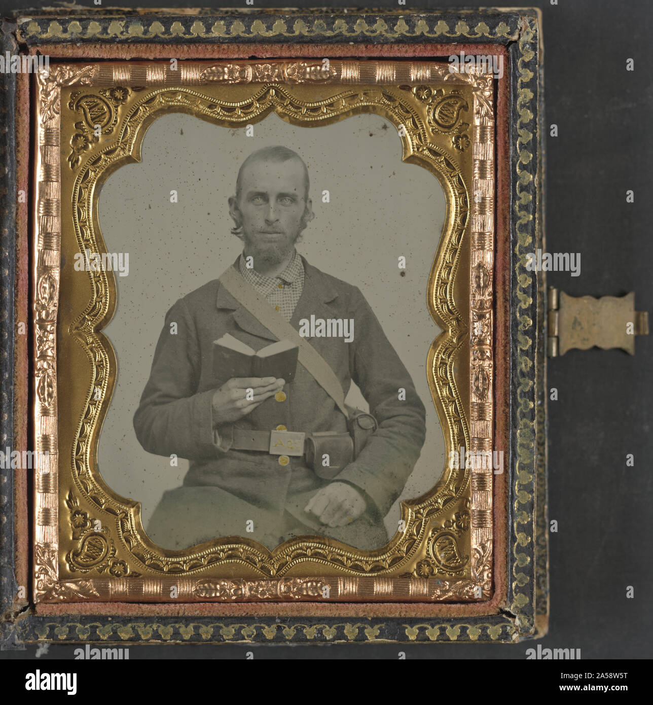 Unidentified soldier in Confederate uniform and C.S.A. belt buckle with